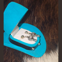 AWST EARRING IN A COWBOY SHAPED GIFT BOX